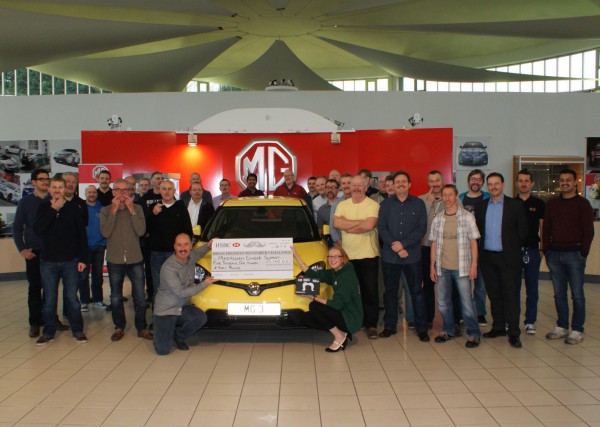 MG design and engineering staff pose alongside their well deserved cheque for Macmillan Cancer Support.