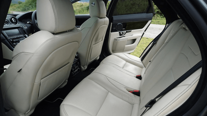 Rear legroom isn't too bad but headroom is restricted. Rear bench is comfy and passengers have their own climate system. It looks as nice as it smells too.